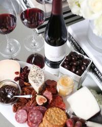 charcuterie board and a bottle of wine